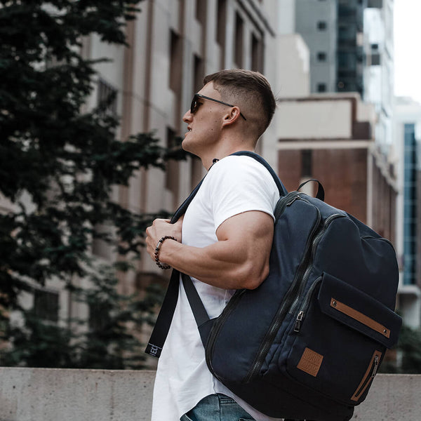 Man wearing Black backpack work bag laptop bag travel bag gym bag carry on recycled